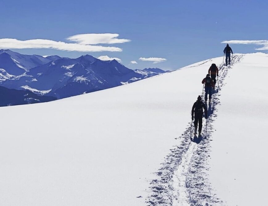 skiers heading up a mountain