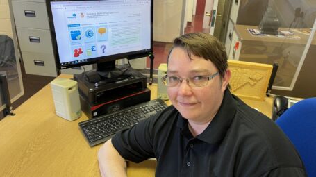 Woman in front of computer with ParentPay system on it