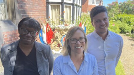 Three people smiling at the camera