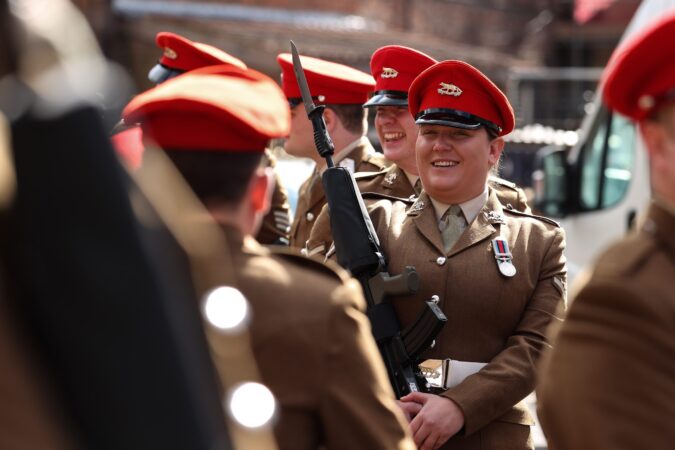 A woman in army uniform smiling