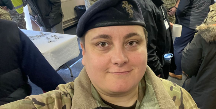 Woman in army cadet uniform smiling at the camera