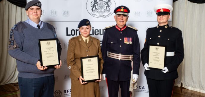 four people in uniform standing in a row