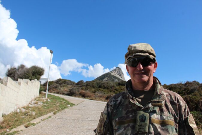 adult volunteer in sunglasses against blue skies