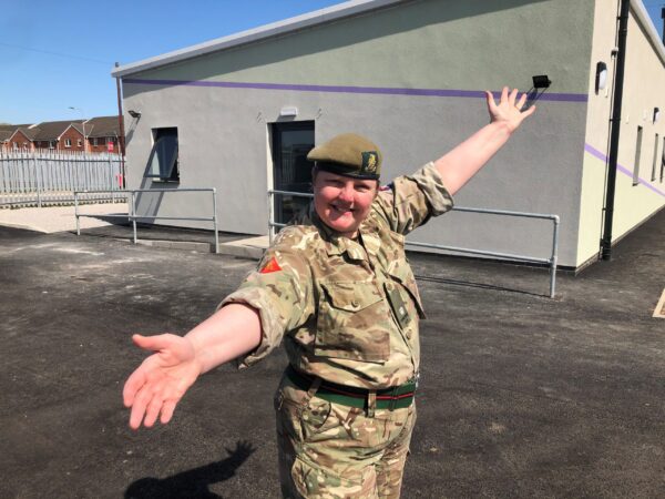Cadet force adult volunteer outside new cadet hut