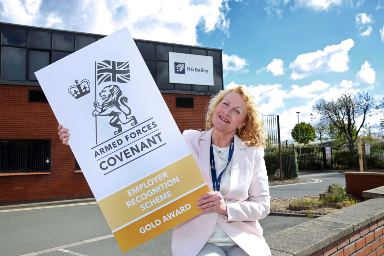 Woman holding Gold Award placard