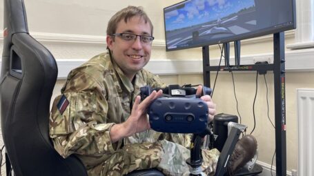 Adult volunteer in combats in front of computer screen