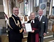 Air commodore with a priest and a man in a suit