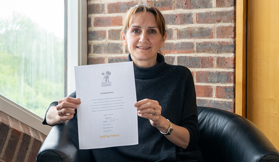 Woman holding an Armed Forces Covenant Document