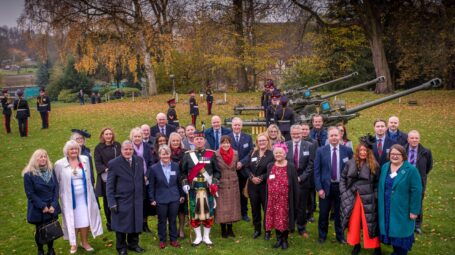 Civilian group in front of artillery guns