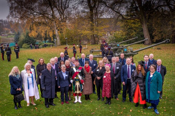 Civilian group in front of artillery guns