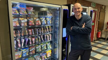 man next to vending machine