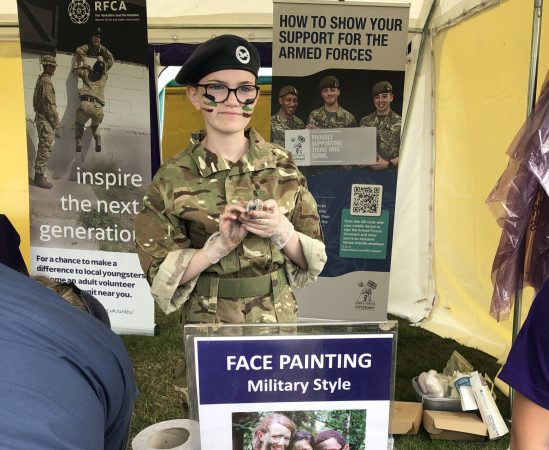 Cadet with face paint in a tent